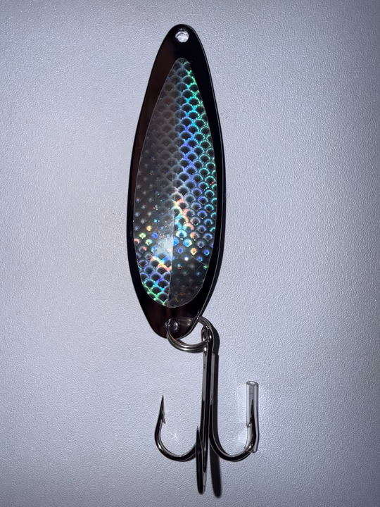 A close-up of a reflective spoon fishing lure